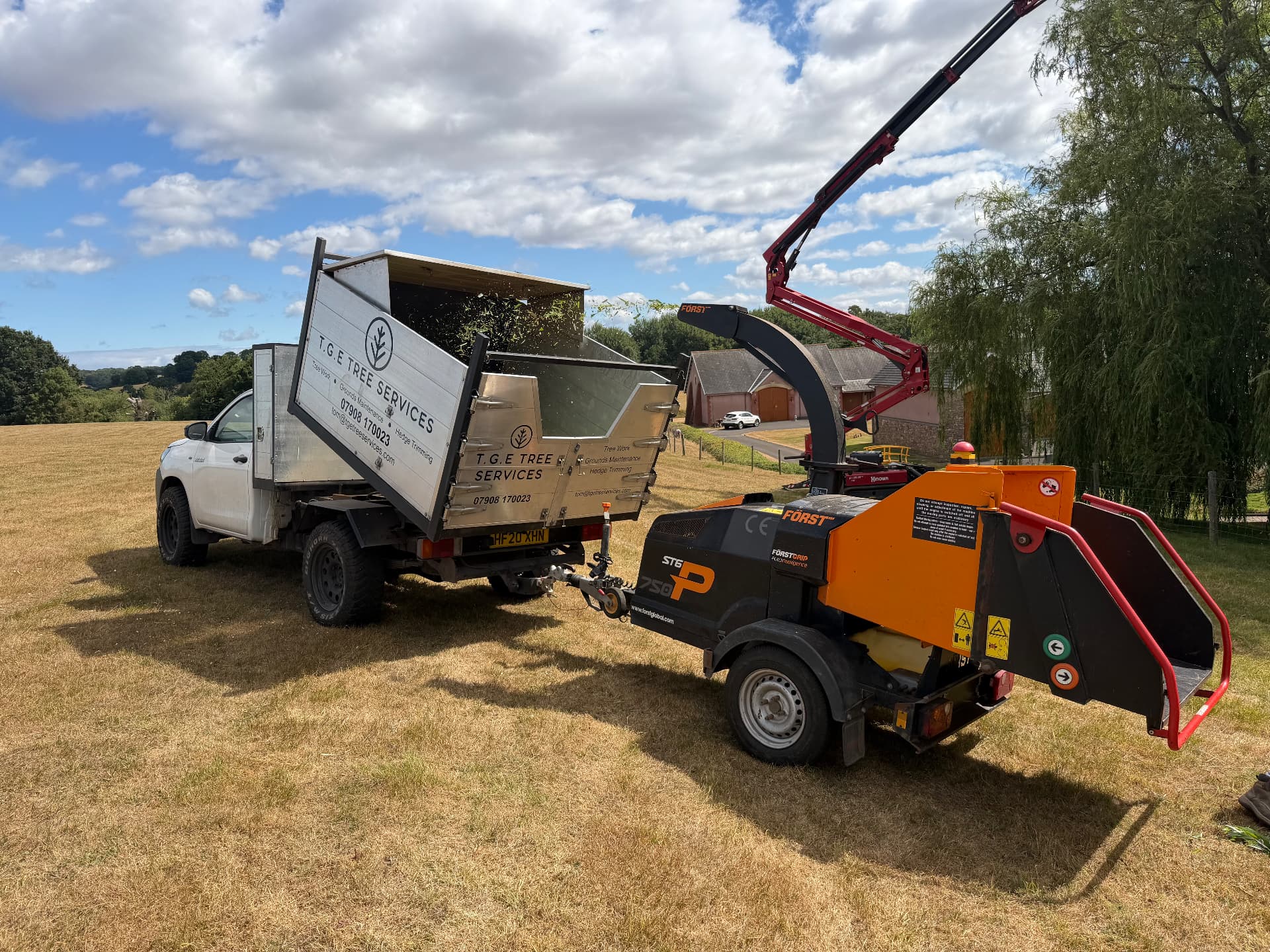 TGE Tree Services tipper truck and Först wood chipper on site in Devon